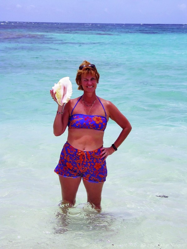 Nancy with a conch shell at Nancy and Walker's secret beach on Anegada