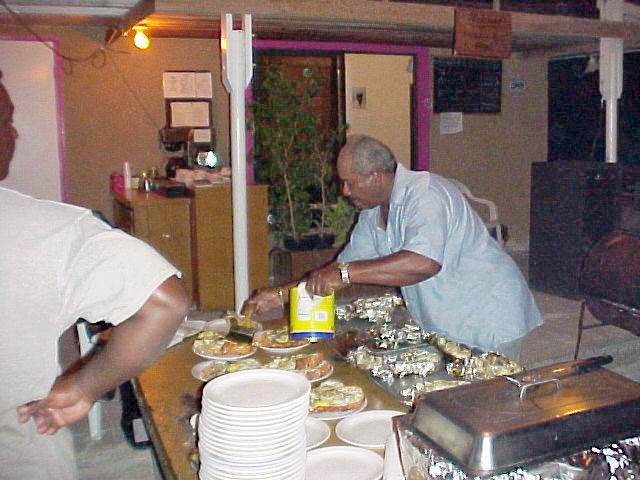 Lowell putting finishing touch on dinner, 2002