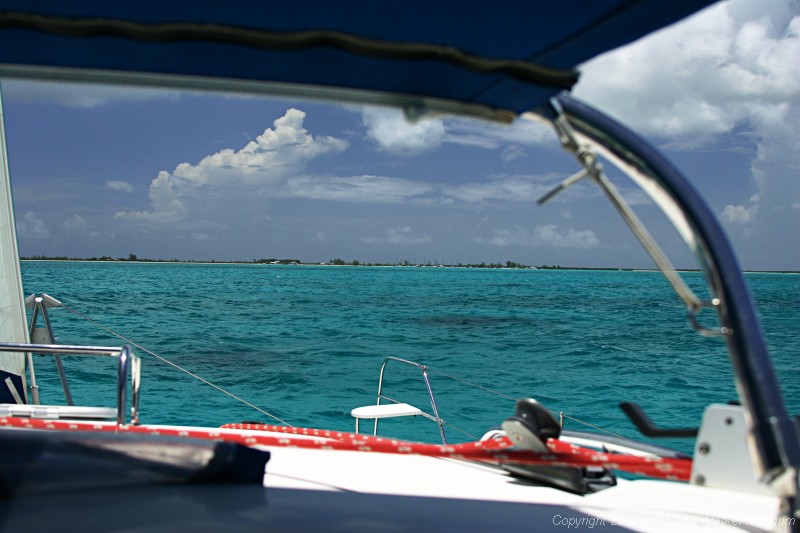 Anegada from one half mile out. A normal view, as it would appear without binoculars. The red entrance buoy is visible below Neptune's Treasure, just below the beach.