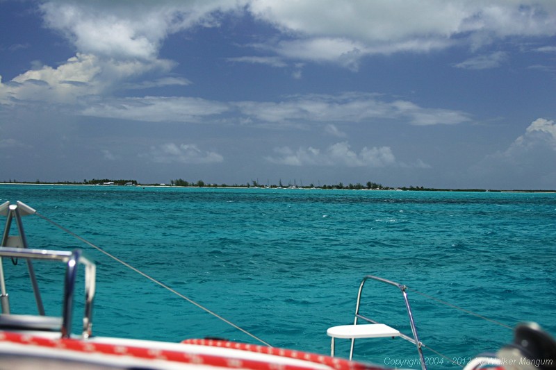 Anegada from one half mile out. A normal view, as it would appear without binoculars. The red entrance buoy is visible below Neptune's Treasure, just below the beach.